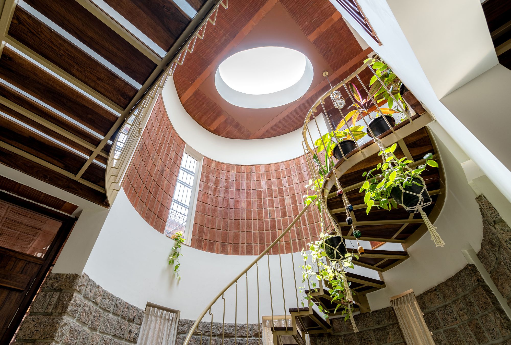 A compact home designed to connect with the sky sits on a quaint street in Bengaluru.