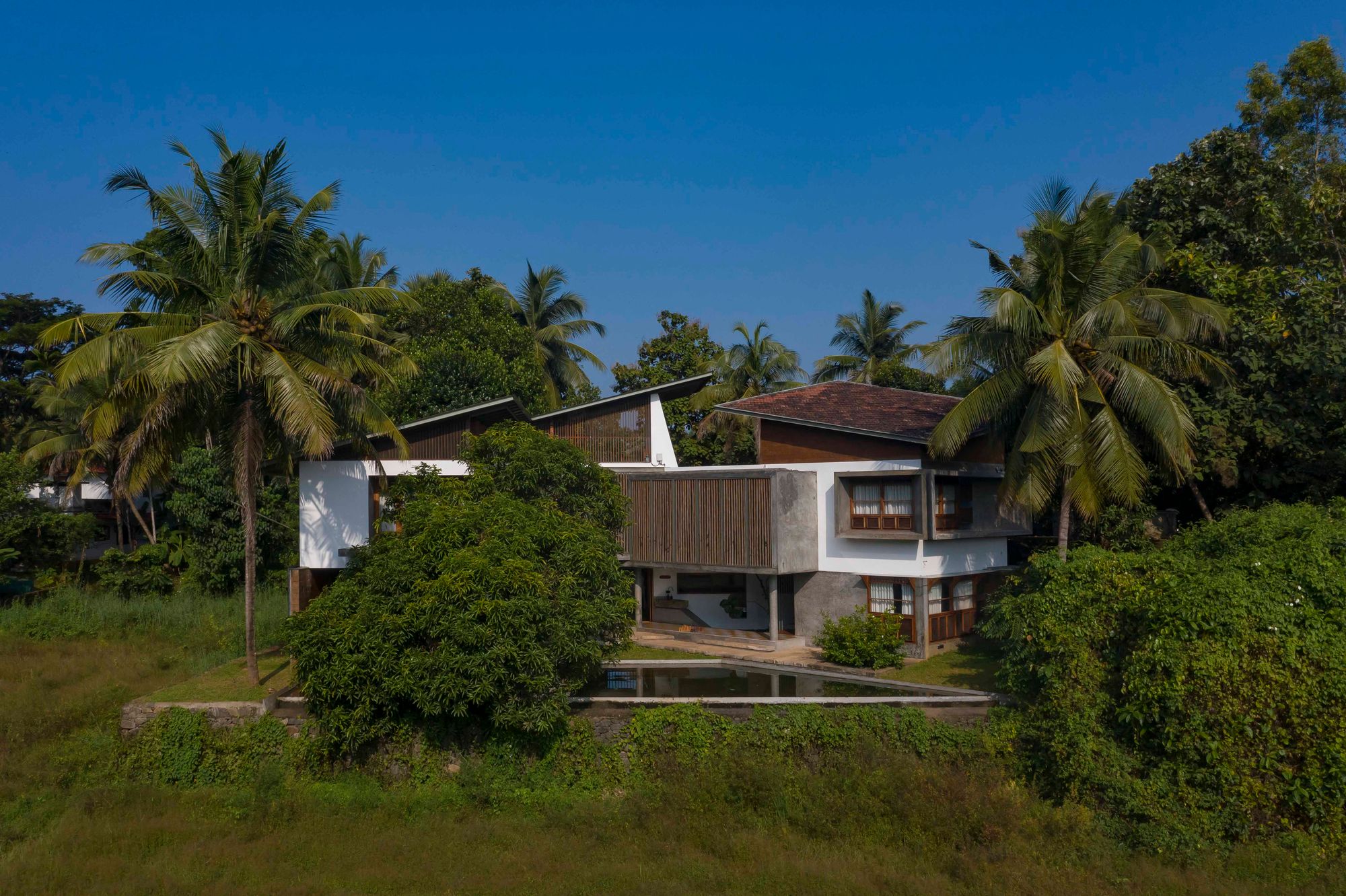 architecture, interior, Kerala, home, Sloping roof, pond, weather condition, sustainable, sustainability hero, eco-friendly