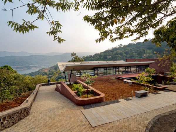 Curled up in the valleys of Panshet, this coy house stays rooted in nature