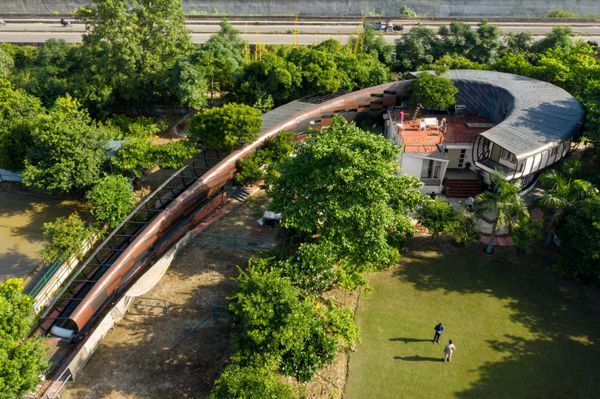 On the outskirts of Noida, this striking home emerges from the earth and blends with nature